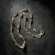 Silver WALLET chain on a dark textured background