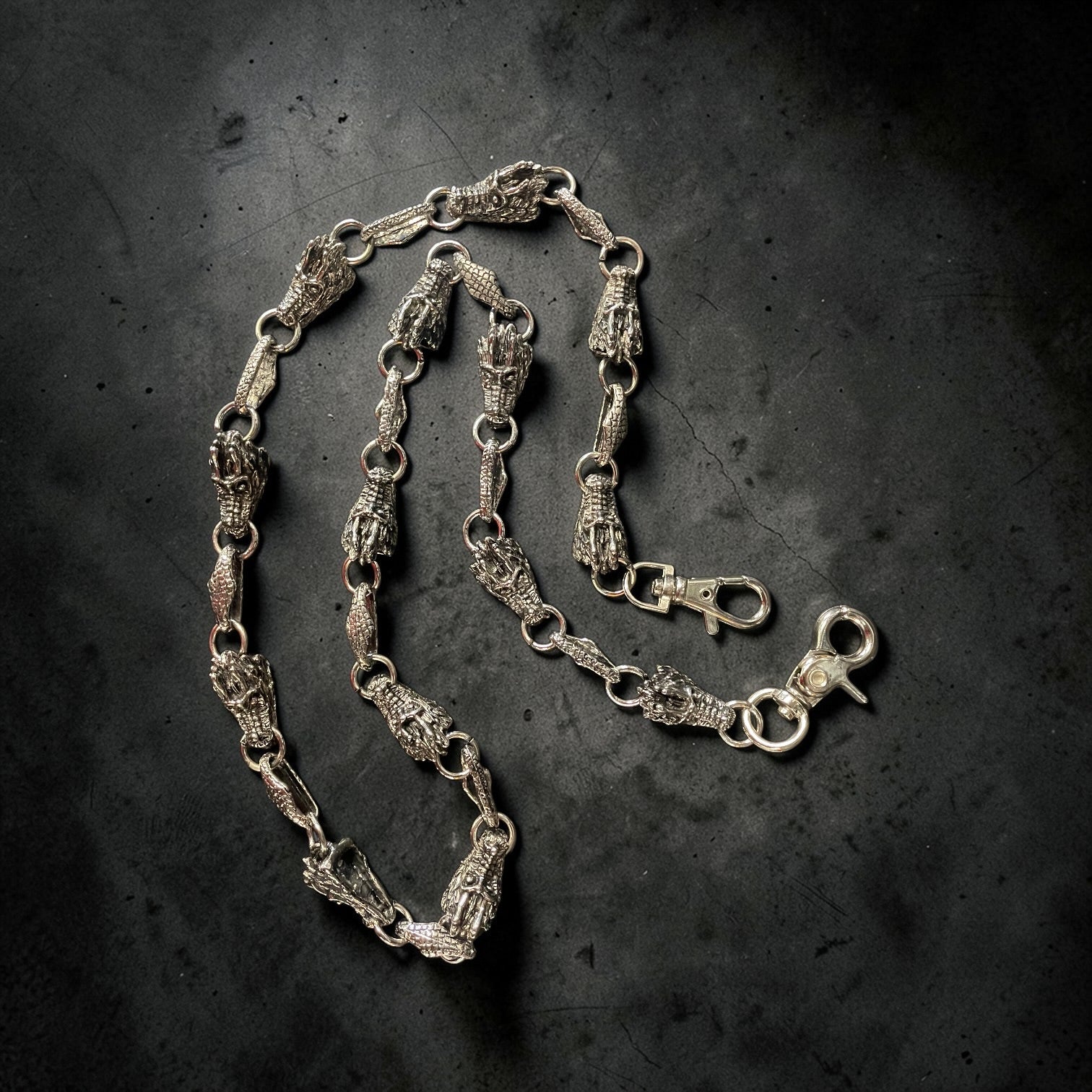 Silver WALLET chain on a dark textured background