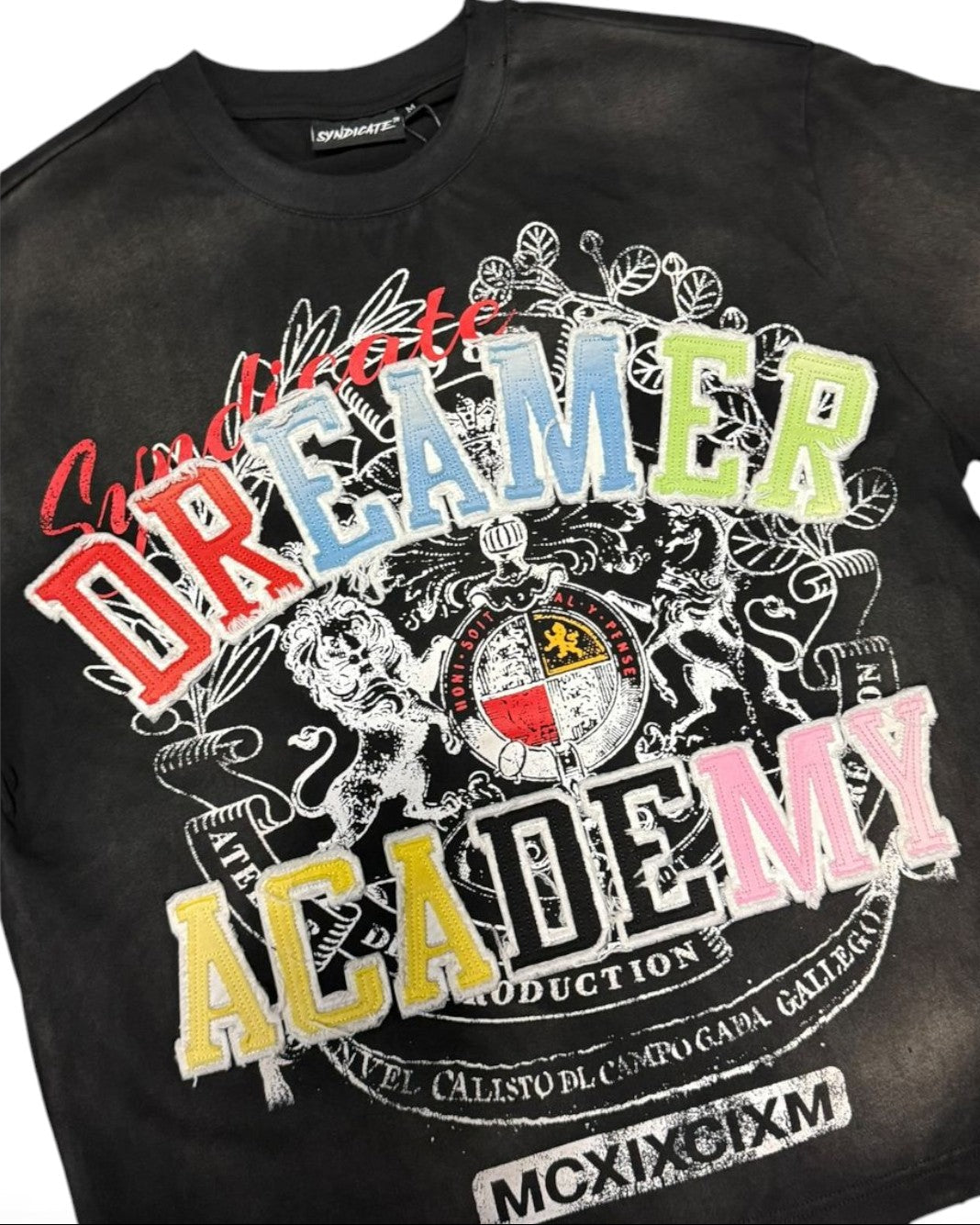 Black t-shirt with colorful graphics and text on a white background