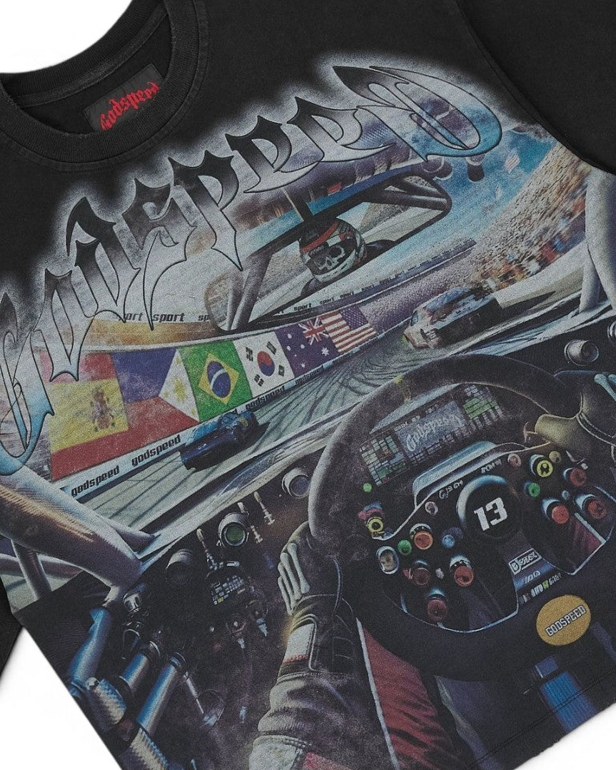 Black t-shirt with a detailed graphic of a race car interior and 'Outlandish' branding.