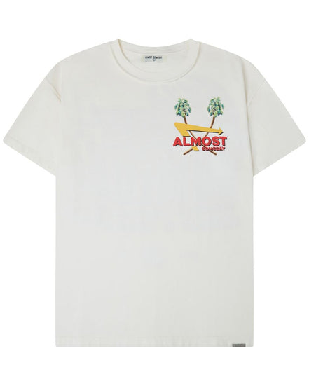 An off-white short-sleeve t-shirt with a colorful chest graphic featuring two green palm trees, a yellow surfboard, and the red text 'ALMOST SOMEDAY'.