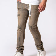 Person wearing beige distressed jeans and white sneakers on a white background