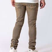 Person wearing brown jeans and white sneakers on a white background