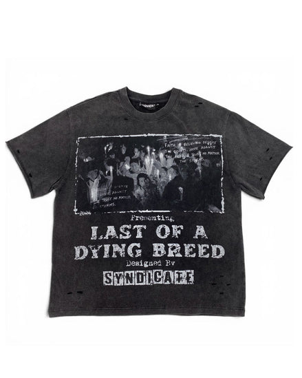 A dark gray washed graphic t-shirt featuring a black-and-white band photo and distressed white text reading 'Presenting Last of a Dying Breed' and 'Designed by Syndicare'.