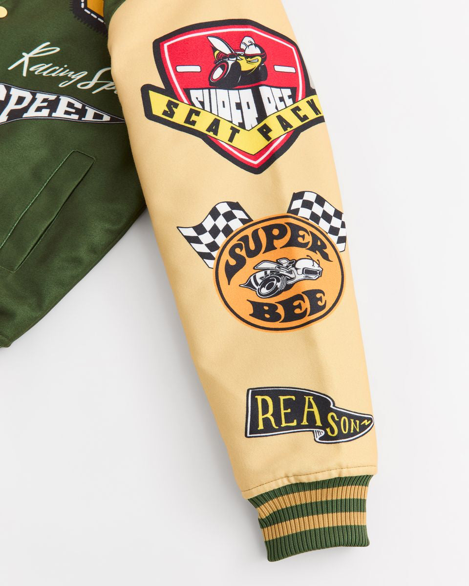 Close-up of a yellow jacket with 'Super Bee' and 'Reason' patches on a white background