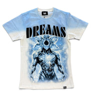 A short-sleeve graphic t-shirt featuring a blue and white tie-dye gradient, with a large black and white 'DREAMS' text print and a blue skeletal flower-headed creature graphic on the front.
