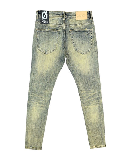 Distressed blue jeans with a brand label on a white background