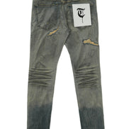 Distressed denim jeans with a brand label on a white background