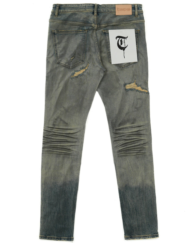 Distressed denim jeans with a brand label on a white background