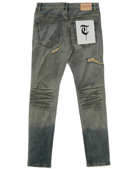 Distressed denim jeans with a brand label on a white background