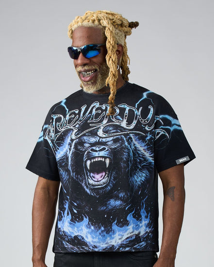 Man wearing a black t-shirt with a gorilla graphic and 'Deliver Us' text on a gray background
