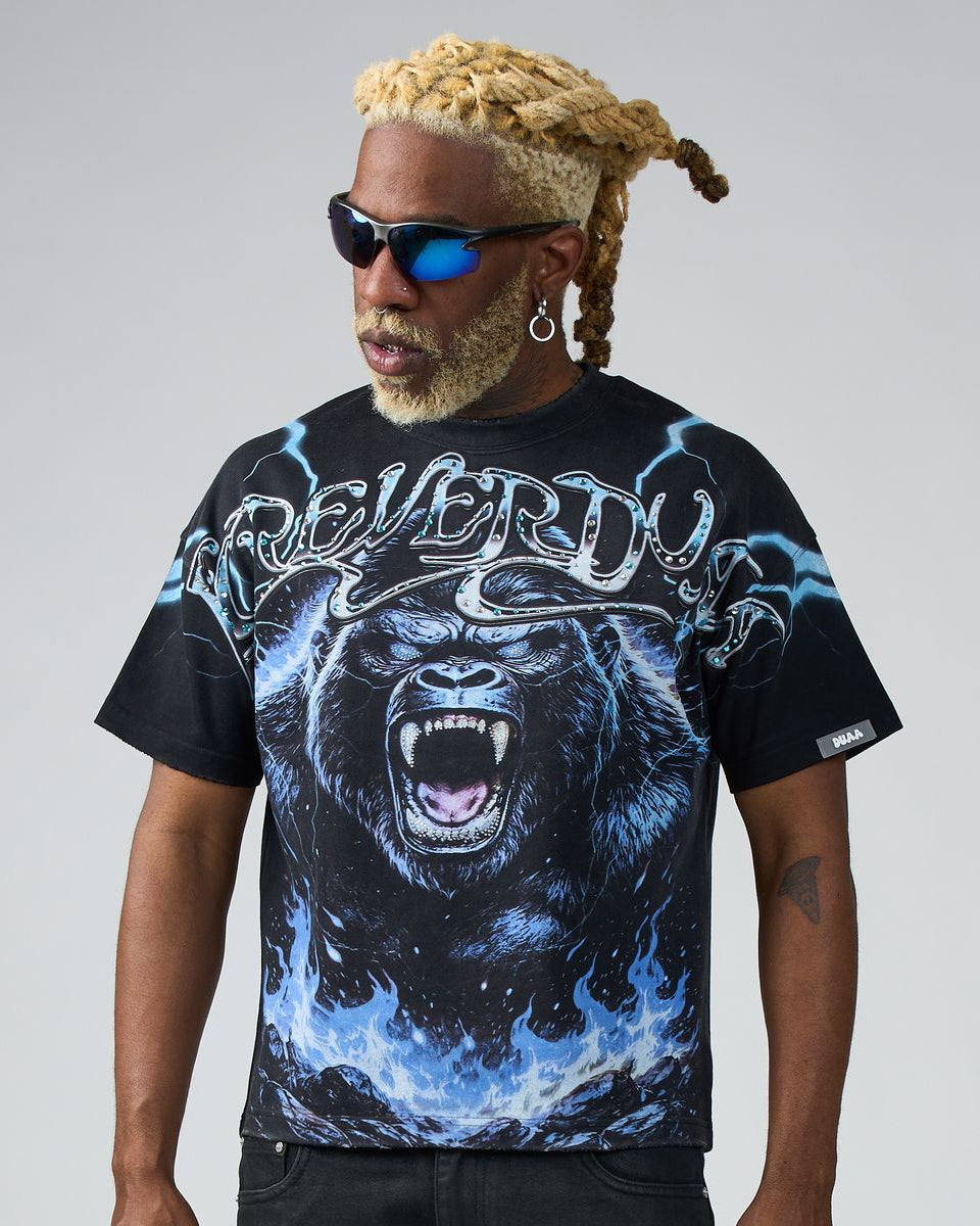 Person wearing a black t-shirt with a graphic design of a gorilla and text on a gray background