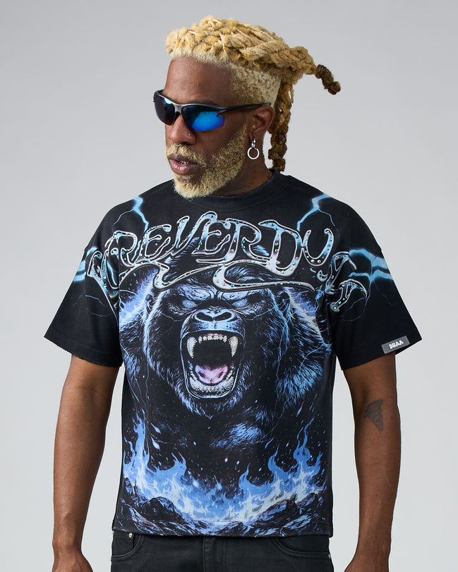 Person wearing a black t-shirt with a graphic design of a gorilla and text on a gray background