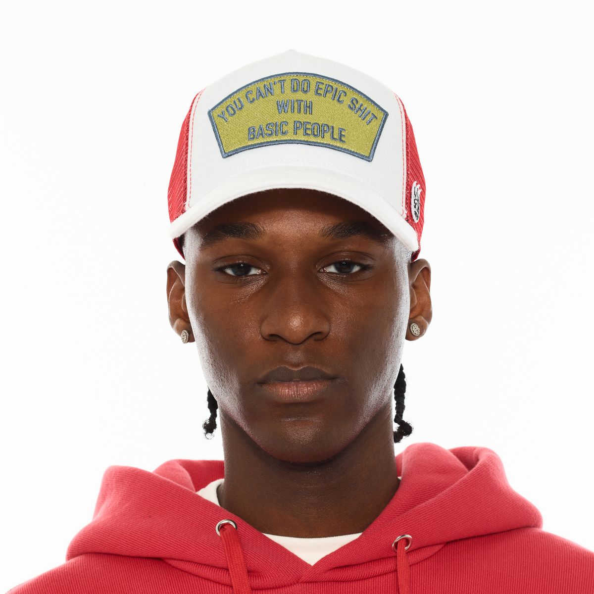 Person wearing a red and white cap with text and a red hoodie on a white background
