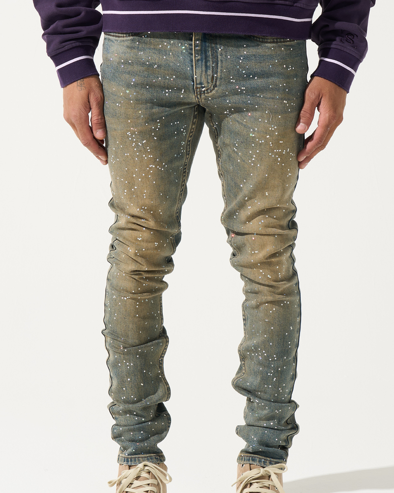 Person wearing a pair of distressed jeans with a white background
