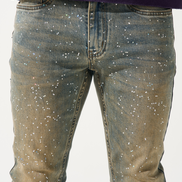 Blue jeans with star patterns worn by a person on a white background