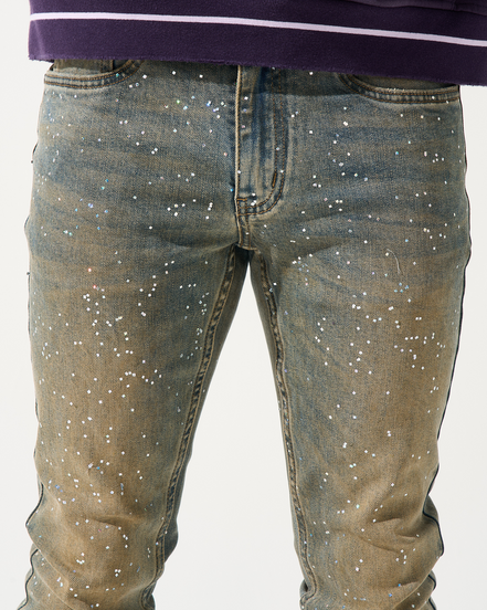 Blue jeans with star patterns worn by a person on a white background