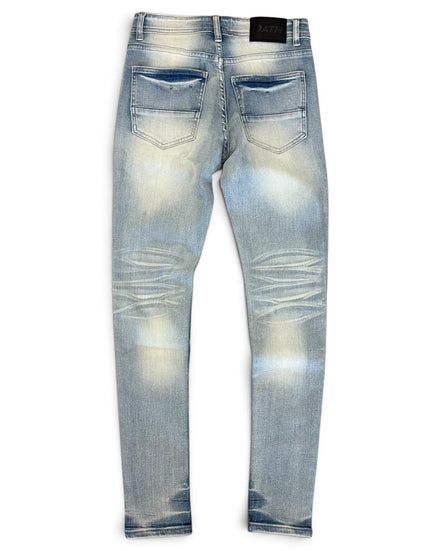 Light blue distressed skinny jeans shown from the back, featuring faded wash details and a black leather patch at the back waistband, set against a plain white background.