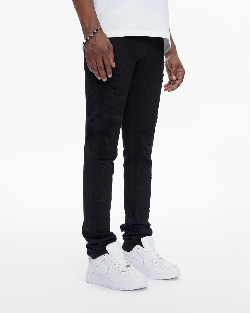 Person wearing black cargo pants and white sneakers on a white background