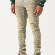 Person wearing beige distressed jeans and maroon and white sneakers on a white background