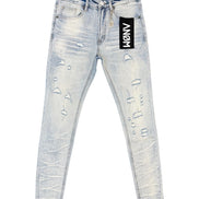 Light wash blue distressed skinny jeans with ripped details and a black brand patch on the pocket, shown flat on a white background.