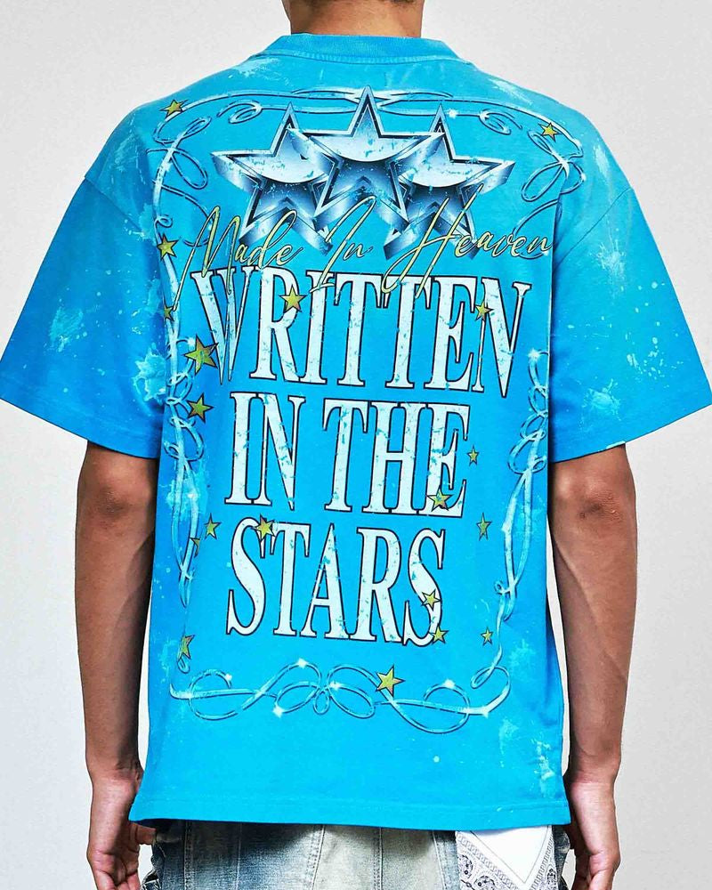 Blue t-shirt with 'Written in the Stars' text and star designs on a plain background