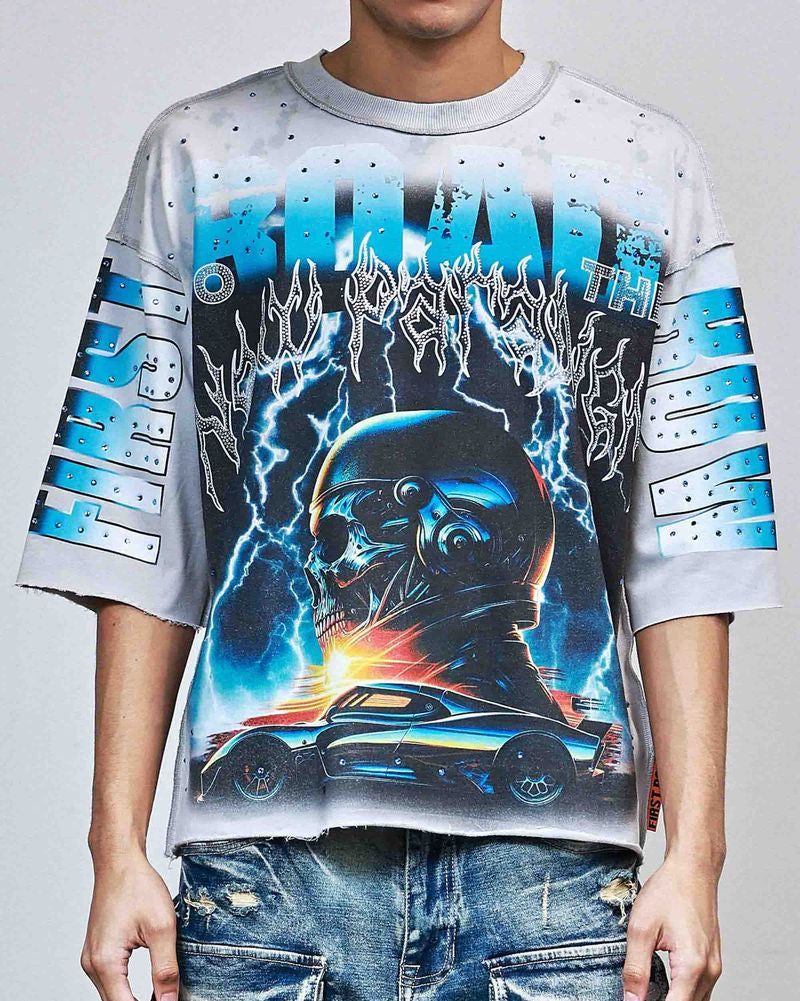 Person wearing a graphic t-shirt with a car and storm design on a plain background