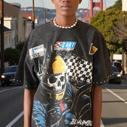 Person wearing a graphic t-shirt with a skull and racing helmet design, standing on a street with the Golden Gate Bridge in the background.