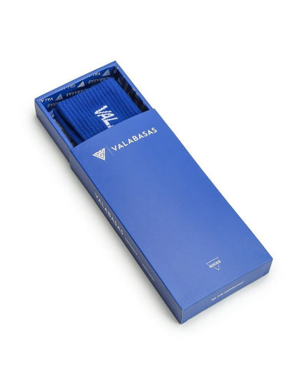 Blue Valerbasas box with a folded blue fabric inside on a white background