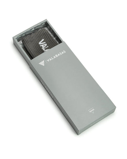 Gray box with a grey item inside, branded 'VALABASAS', on a white background