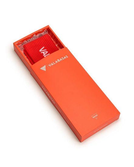 Red sock with 'VALARABAS' branding in an orange box on a white background