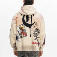 Person wearing a cream hoodie with black and red graphics on the back, standing against a white background.