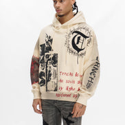 Person wearing a cream hoodie with black and red text and graphics on a white background