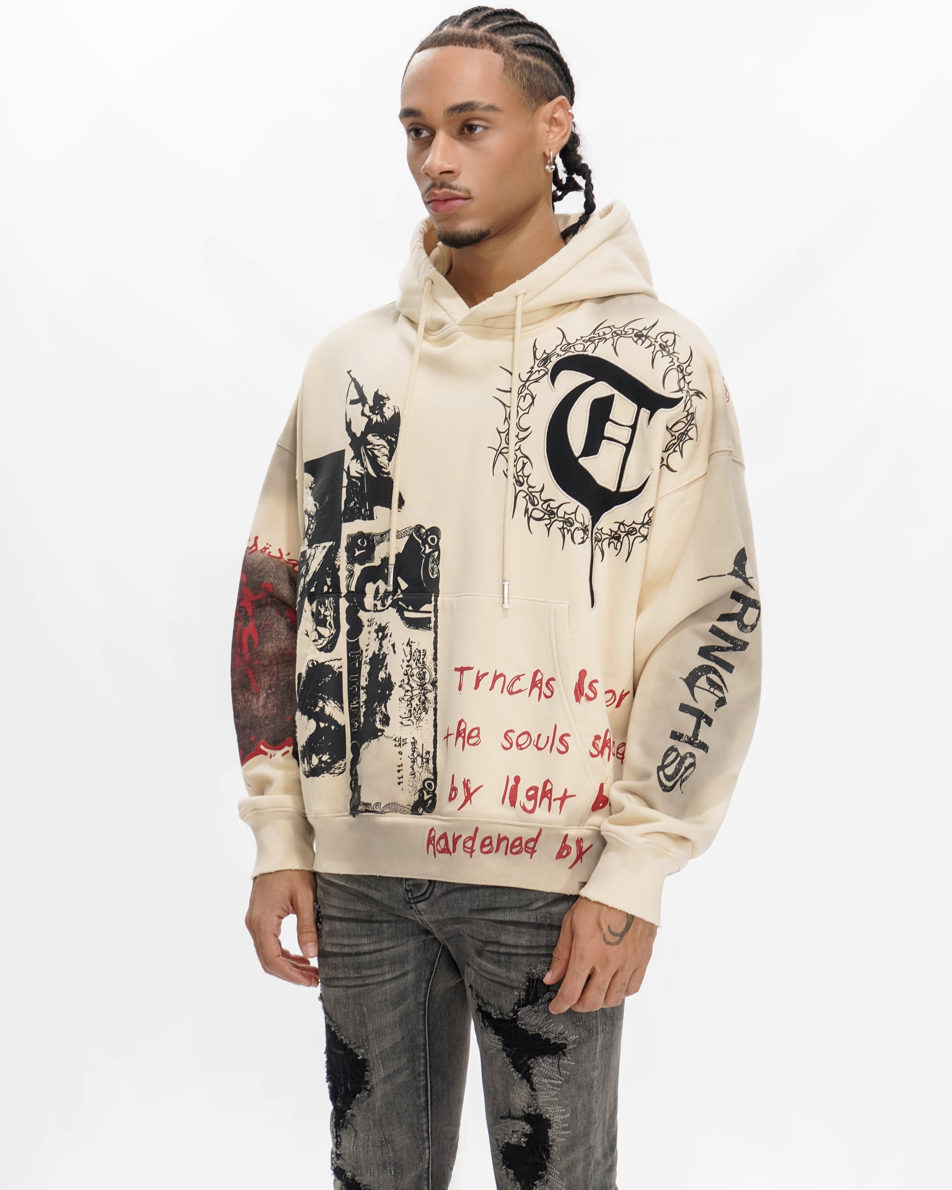 Person wearing a cream hoodie with black and red text and graphics on a white background