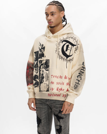 Person wearing a cream hoodie with black and red text and graphics on a white background