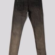 Back view of a pair of slim-fit jeans in a washed charcoal gray color, showing the back pockets and a subtle distressed detail on one leg, set against a solid gray background.