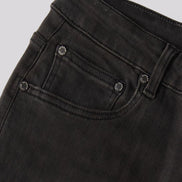 Close-up of a pair of faded black denim jeans showing the waistband, belt loops, and front pocket with metal rivets.