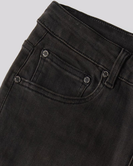 Close-up of a pair of faded black denim jeans showing the waistband, belt loops, and front pocket with metal rivets.