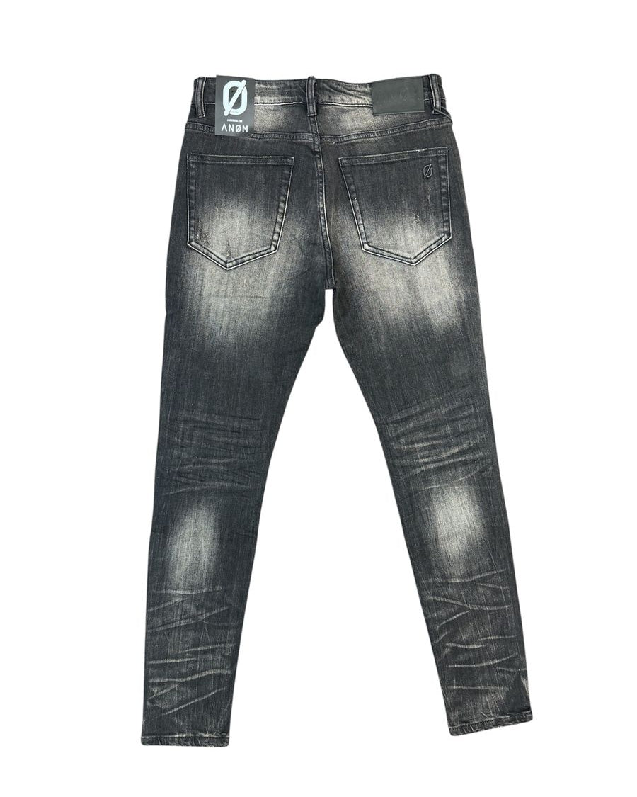 Back view of a pair of dark gray washed skinny jeans with a faded black finish, showing the back pockets and a brand patch on the waistband.