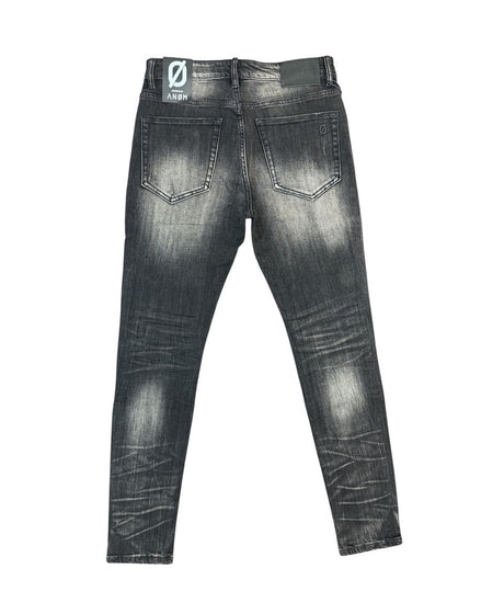 Back view of a pair of dark gray washed skinny jeans with a faded black finish, showing the back pockets and a brand patch on the waistband.