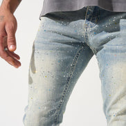 Close-up of light blue jeans with a subtle pattern on a white background