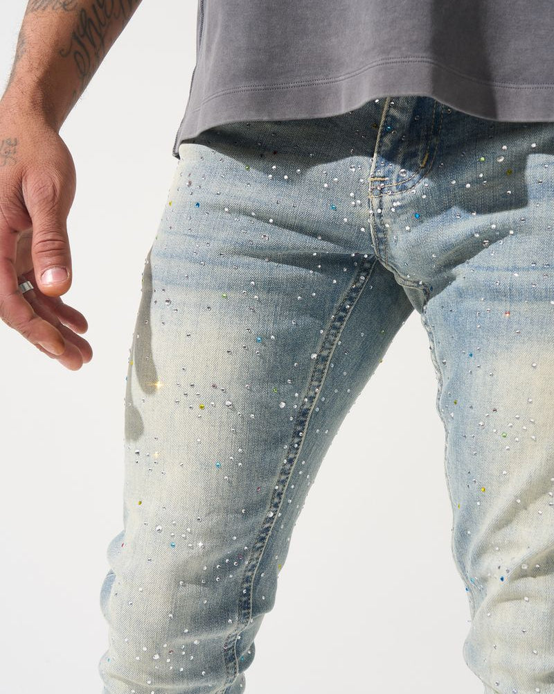 Close-up of light blue jeans with a subtle pattern on a white background