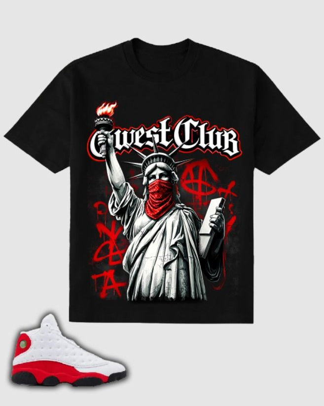 Black t-shirt with graphic design of a masked Statue of Liberty and 'West Club' text, paired with a white and red sneaker.