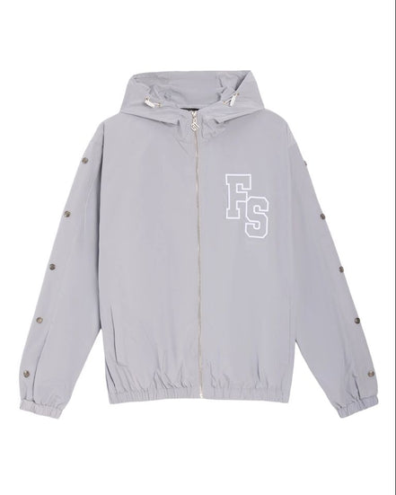 A light gray hooded windbreaker jacket with a white 'FS' monogram logo on the left chest, displayed flat against a white background.