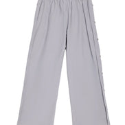 Light gray wide-leg cropped pants with an elastic waistband and decorative side buttons, shown flat on a white background.