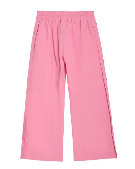 Pink wide-leg cropped pants with an elastic waistband and side buttons, shown flat on a white background.
