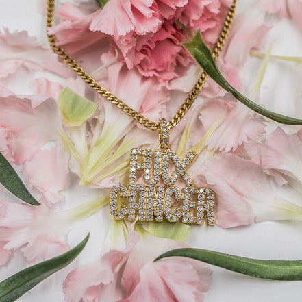 Gold necklace with a 'F**K CANCER' pendant on pink flowers