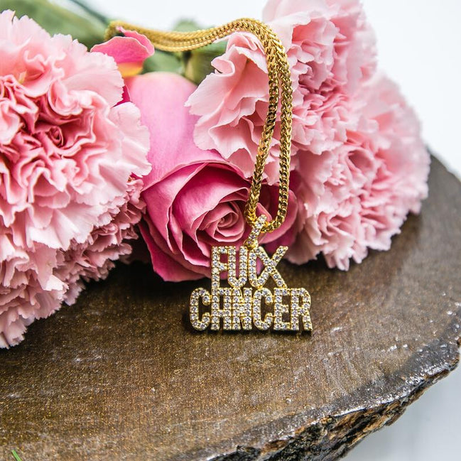 Gold necklace with 'F**K CANCER' pendant on pink flowers