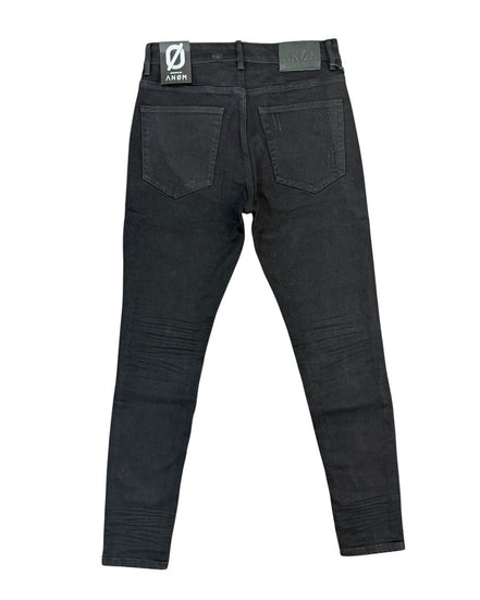 Black denim jeans shown from the back, featuring a dark wash with subtle whiskering and a visible ANOM brand patch on the back waistband.