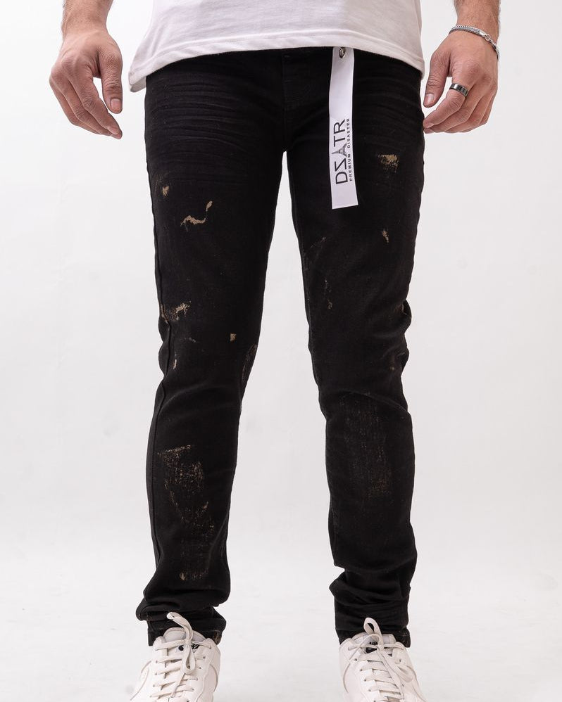 Person wearing black distressed jeans with a visible brand label on a white background